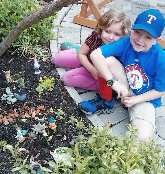 Emersyn and Brody Playing in Fairy Garden